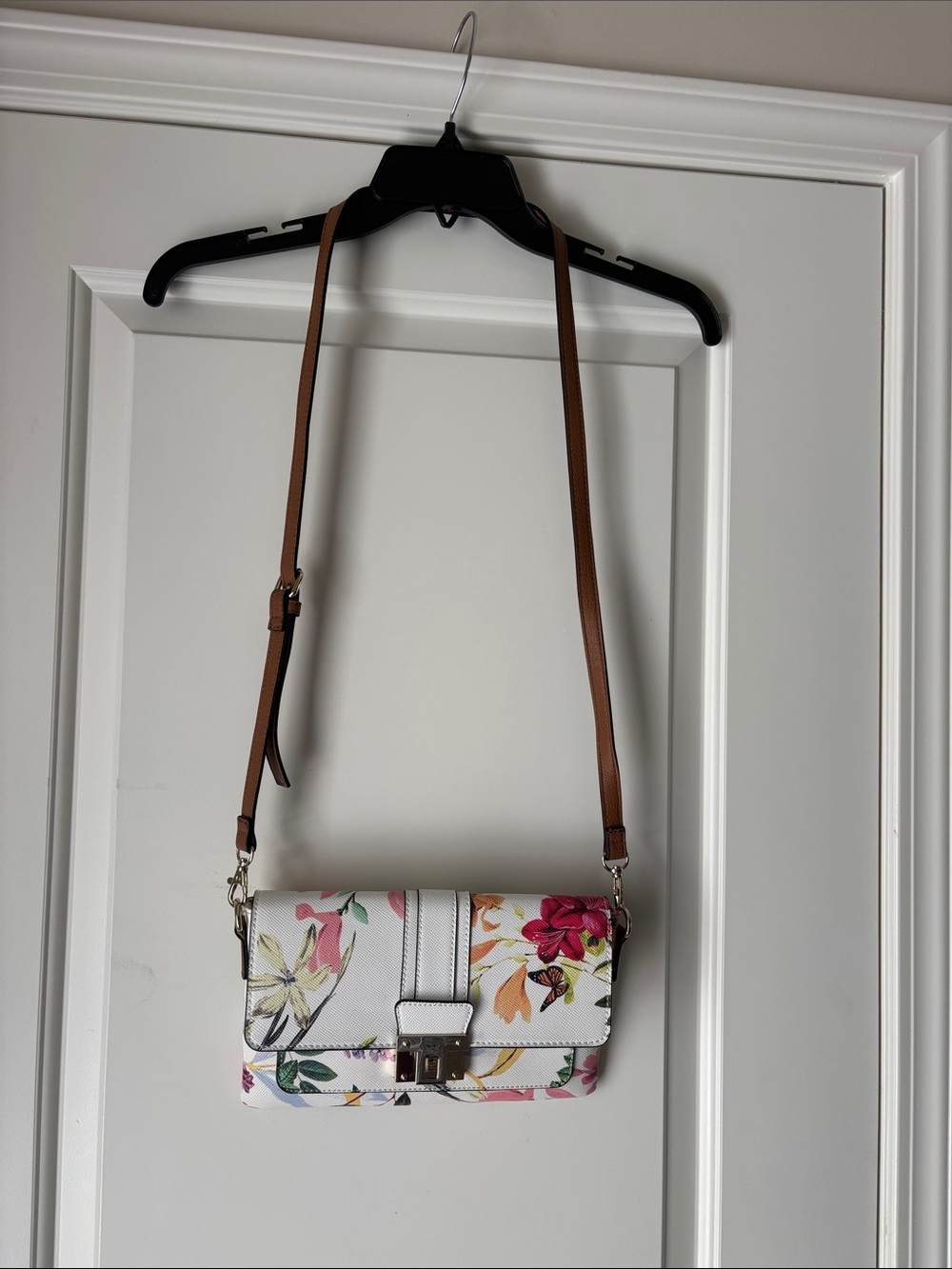New without tags.  Floral White Crossbody Bag with Brown Strap
